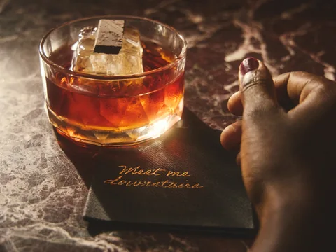 Amber cocktail on a branded coaster at Owner’s Office