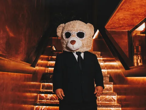 Teddy bear character on the illuminated Owner’s Office staircase