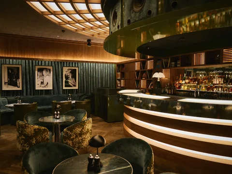 Curved bar and lounge seating inside The Room
