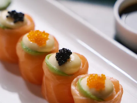 Bite-sized canapés arranged on a white plate at The Room