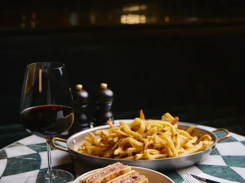 Fries and a plated main course on a table at The Room
