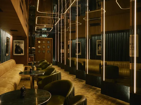 Mirrored walls and intimate dining tables inside The Room
