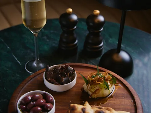 Shared snack platter with small bowls at The Room